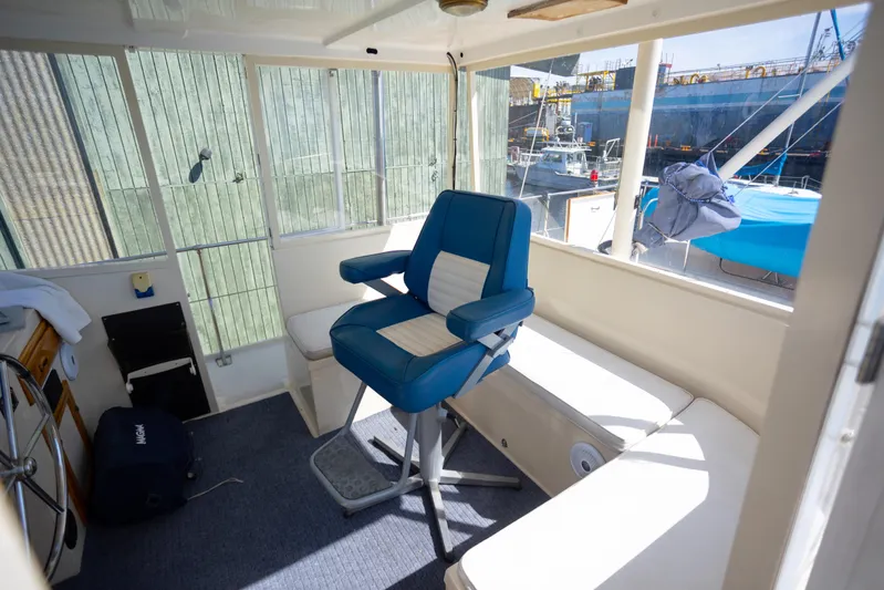 Amazing Grace Yacht Photos Pics Interior of 1983 Kadey-Krogen Manatee 36 with blue captain's chair and windows.