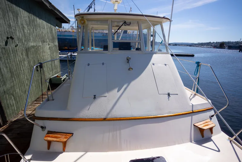 Amazing Grace Yacht Photos Pics 1983 Kadey-Krogen Manatee 36 boat docked by a wooden pier on a sunny day.