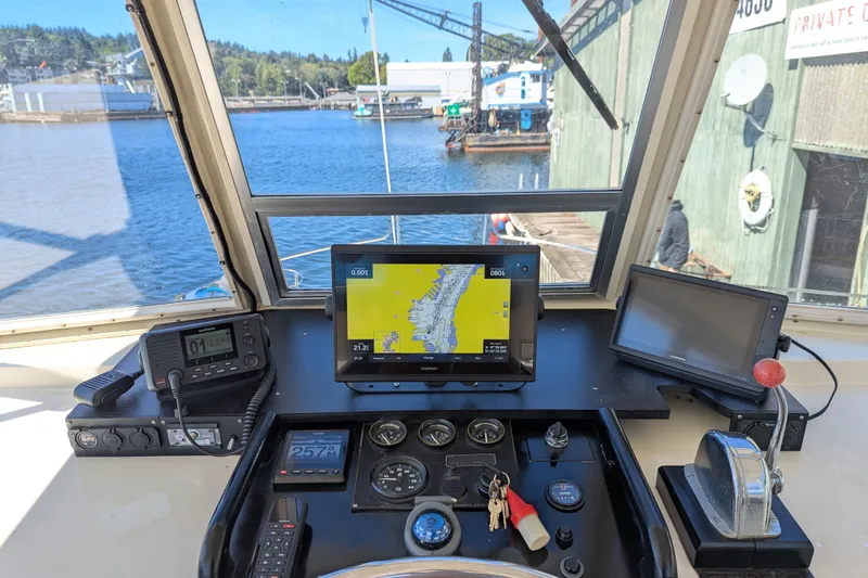 Amazing Grace Yacht Photos Pics 1983 Kadey-Krogen Manatee 36 helm with navigation equipment and waterfront view.