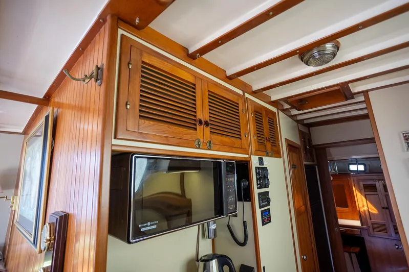 Amazing Grace Yacht Photos Pics Interior of 1983 Kadey-Krogen Manatee 36, featuring wooden cabinets and a microwave.