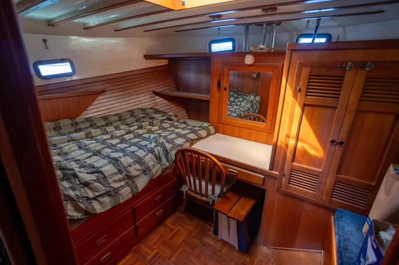 Amazing Grace Yacht Photos Pics Cozy cabin interior of 1983 Kadey-Krogen Manatee 36 with wooden furnishings and bed.