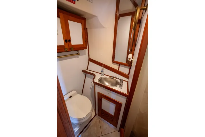 Amazing Grace Yacht Photos Pics 1983 Kadey-Krogen Manatee 36 bathroom with sink, toilet, and wooden cabinetry.