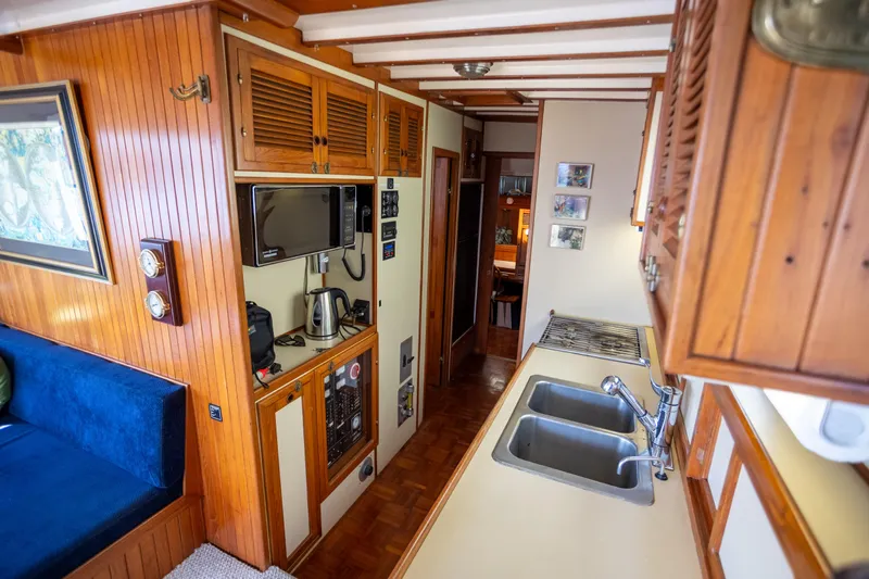 Amazing Grace Yacht Photos Pics 1983 Kadey-Krogen Manatee 36 interior with wooden cabinetry and modern kitchen amenities.