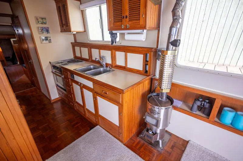Amazing Grace Yacht Photos Pics 1983 Kadey-Krogen Manatee 36 interior kitchen with wood cabinetry and stove.