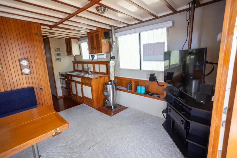 Amazing Grace Yacht Photos Pics 1983 Kadey-Krogen Manatee 36 interior with wood paneling, kitchenette, and entertainment area.
