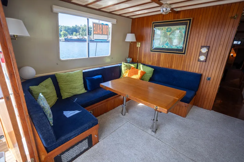 Amazing Grace Yacht Photos Pics 1983 Kadey-Krogen Manatee 36 interior with cozy seating, wooden table, and scenic window view.