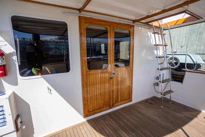 Amazing Grace Yacht Photos Pics 1983 Kadey-Krogen Manatee 36 boat deck with wooden doors and ladder.