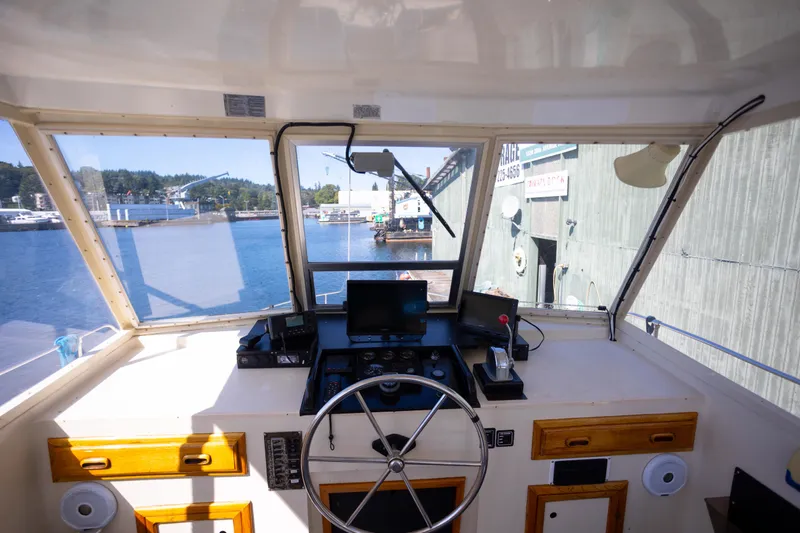 Amazing Grace Yacht Photos Pics Interior view of 1983 Kadey-Krogen Manatee 36 boat cockpit with steering wheel and controls.
