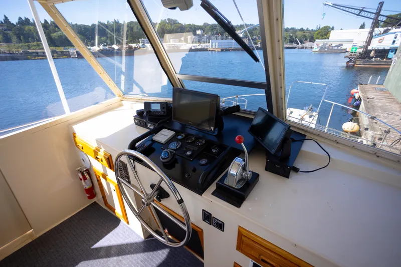 Amazing Grace Yacht Photos Pics 1983 Kadey-Krogen Manatee 36 helm with navigation equipment, overlooking marina.