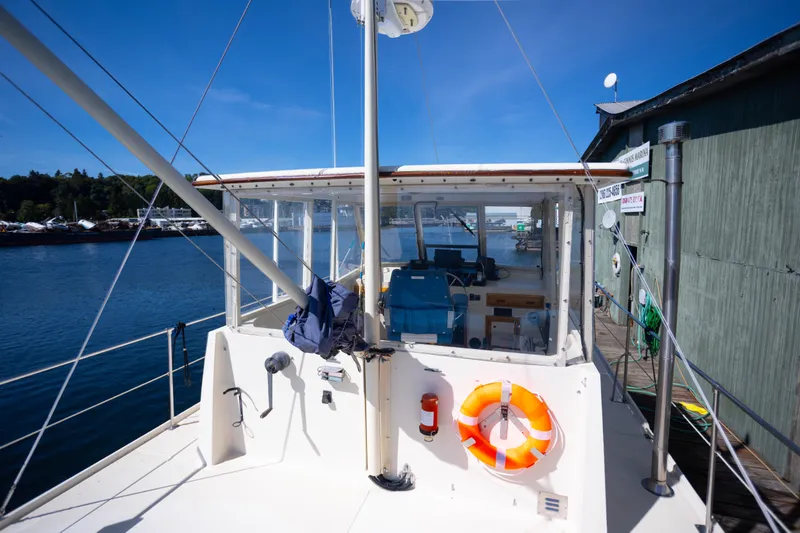 Amazing Grace Yacht Photos Pics 1983 Kadey-Krogen Manatee 36 boat docked, featuring a lifebuoy and clear blue skies.