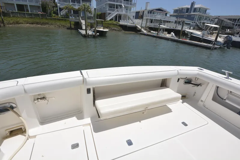 Uncouth Yacht Photos Pics Tiara Yachts 4100 Open 2000 model, spacious deck with seating, docked near waterfront homes.