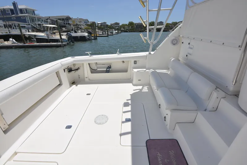 Uncouth Yacht Photos Pics 2000 Tiara Yachts 4100 Open boat deck with seating, docked in a marina.