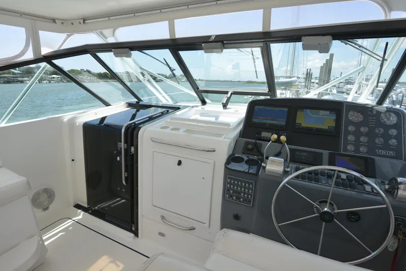 Uncouth Yacht Photos Pics Cockpit of a 2000 Tiara Yachts 4100 Open with navigation instruments and steering wheel.