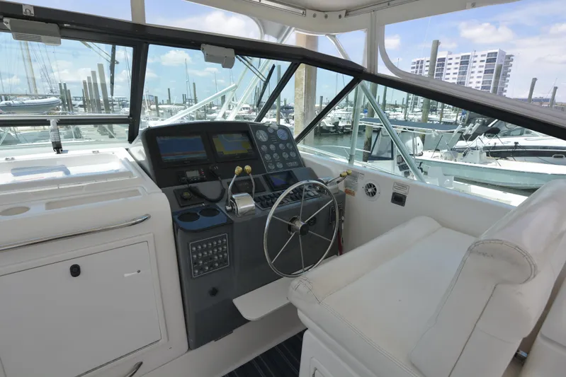 Uncouth Yacht Photos Pics Helm station of 2000 Tiara Yachts 4100 Open with marina view.
