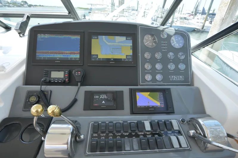 Uncouth Yacht Photos Pics Control panel of a 2000 Tiara Yachts 4100 Open with navigation screens and gauges.