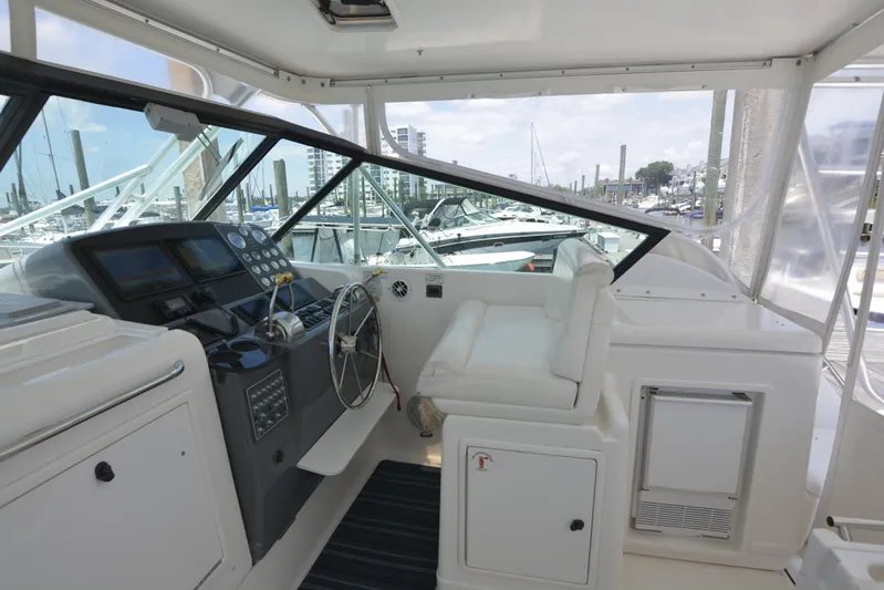 Uncouth Yacht Photos Pics Helm station of 2000 Tiara Yachts 4100 Open with white seating and modern controls.