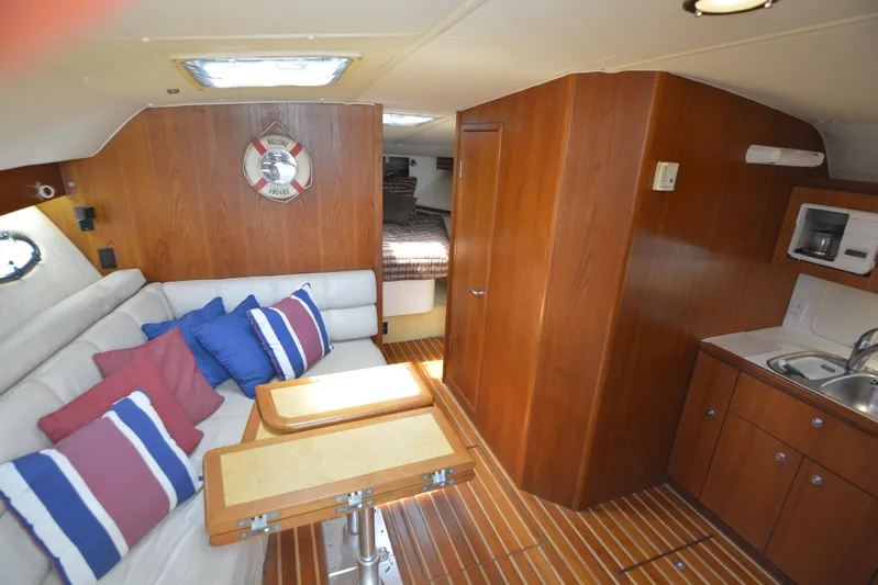 Uncouth Yacht Photos Pics Interior of 2000 Tiara Yachts 4100 Open with cozy seating and kitchenette.
