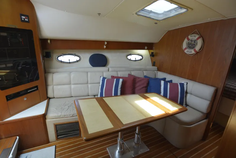Uncouth Yacht Photos Pics Interior of 2000 Tiara Yachts 4100 Open with cozy seating and dining area.