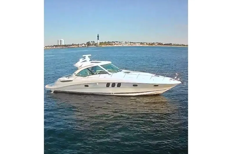  Yacht Photos Pics 2006 Sea Ray 48 Sundancer yacht cruising on calm blue waters.