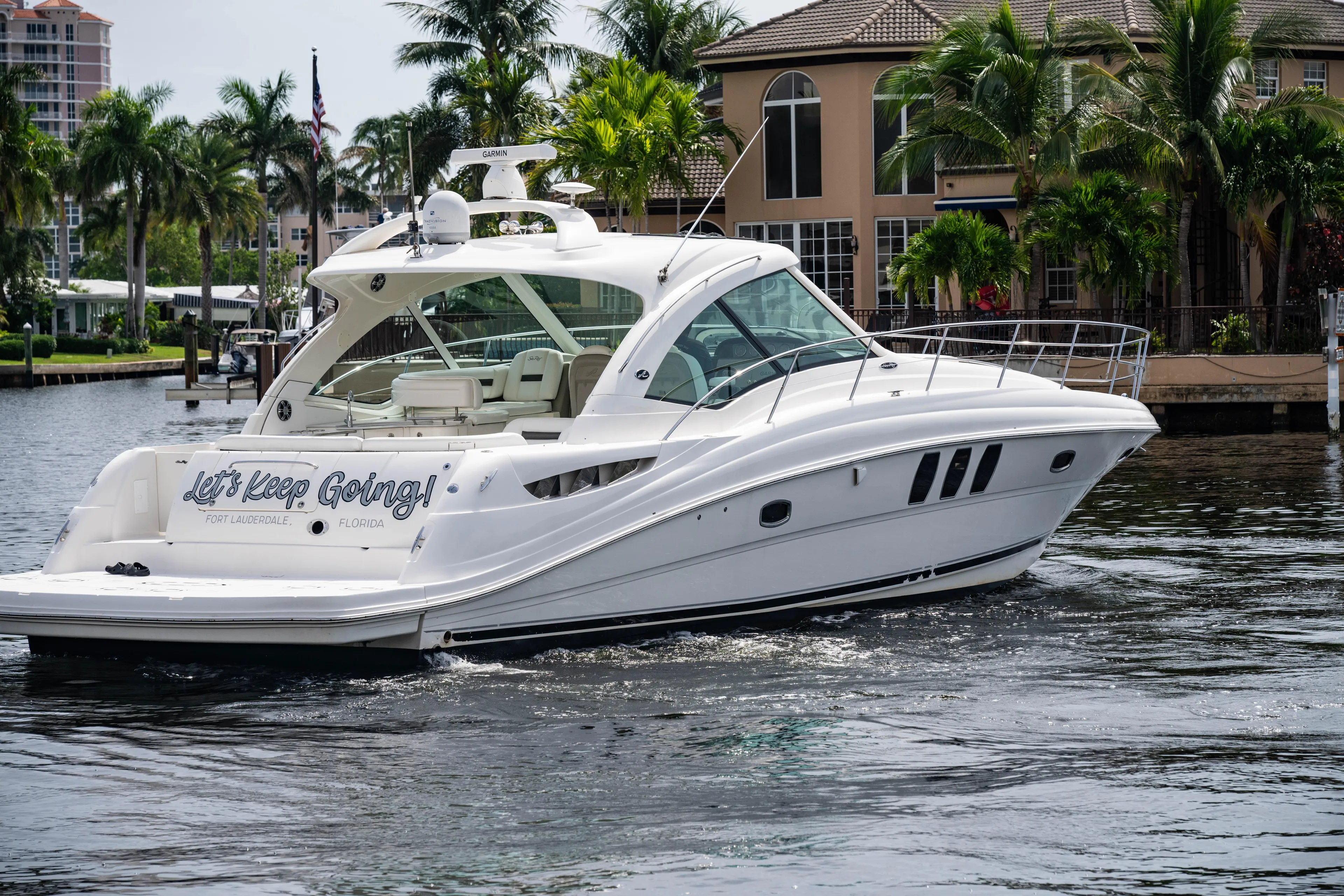  Yacht Photos Pics 2006 Sea Ray 48 Sundancer yacht cruising near waterfront homes.