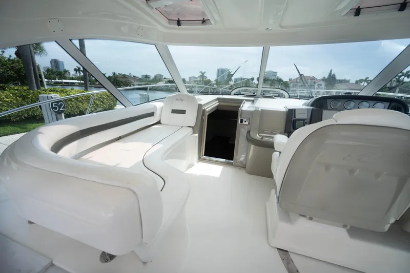  Yacht Photos Pics Luxurious interior of 2006 Sea Ray 48 Sundancer yacht with plush seating and helm.
