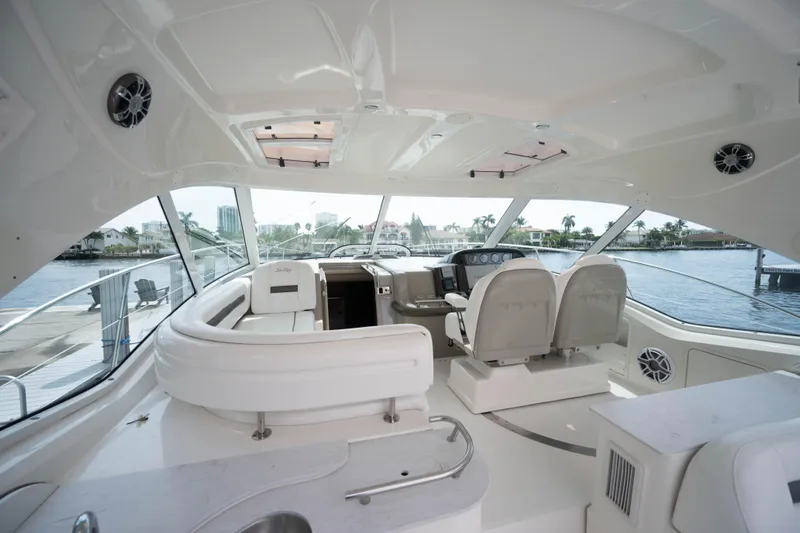  Yacht Photos Pics 2006 Sea Ray 48 Sundancer yacht interior with helm, seating, and waterfront view.