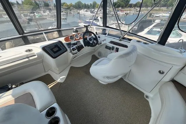 The Wanderer Yacht Photos Pics 2005 Meridian 368 Motoryacht helm with modern controls and panoramic marina view.