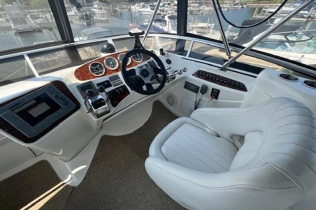 The Wanderer Yacht Photos Pics 2005 Meridian 368 Motoryacht helm with white leather seat and modern controls.