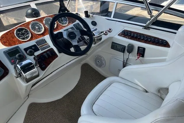 The Wanderer Yacht Photos Pics 2005 Meridian 368 Motoryacht helm with steering wheel, gauges, and control panel.