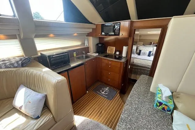 The Wanderer Yacht Photos Pics Interior of 2005 Meridian 368 Motoryacht with kitchen and cozy seating area.