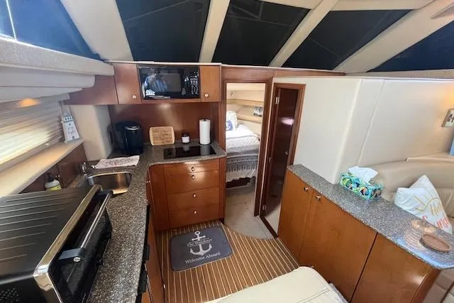 The Wanderer Yacht Photos Pics Interior of 2005 Meridian 368 Motoryacht with modern kitchen and cozy bedroom.