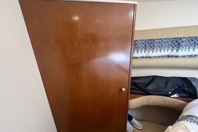 The Wanderer Yacht Photos Pics Interior cabin of 2005 Meridian 368 Motoryacht with wooden cabinet and patterned upholstery.