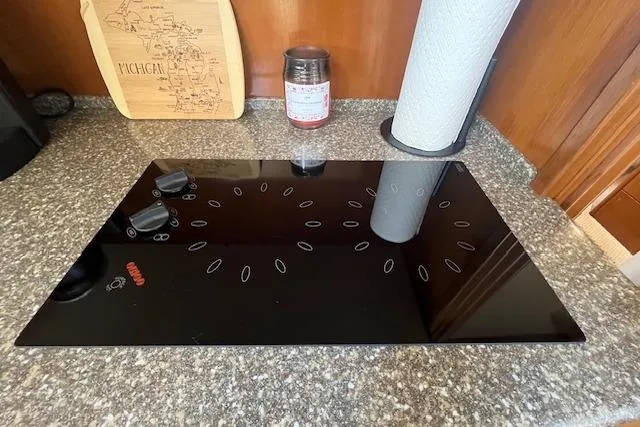 The Wanderer Yacht Photos Pics Modern black cooktop on granite countertop in 2005 Meridian 368 Motoryacht kitchen.