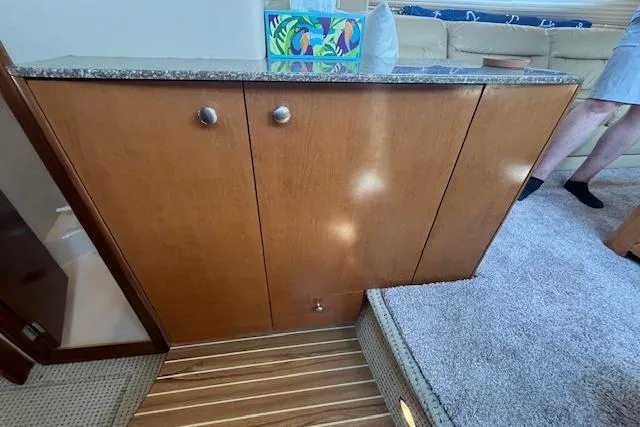 The Wanderer Yacht Photos Pics 2005 Meridian 368 Motoryacht interior with wooden cabinetry and carpeted flooring.