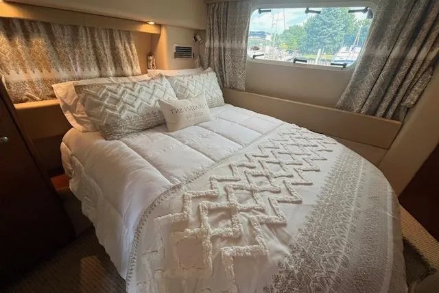 The Wanderer Yacht Photos Pics Luxurious bedroom interior of 2005 Meridian 368 Motoryacht with elegant bedding and window view.