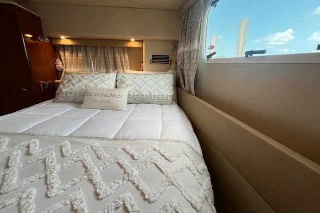The Wanderer Yacht Photos Pics Luxurious bedroom interior of 2005 Meridian 368 Motoryacht with elegant bedding and window view.