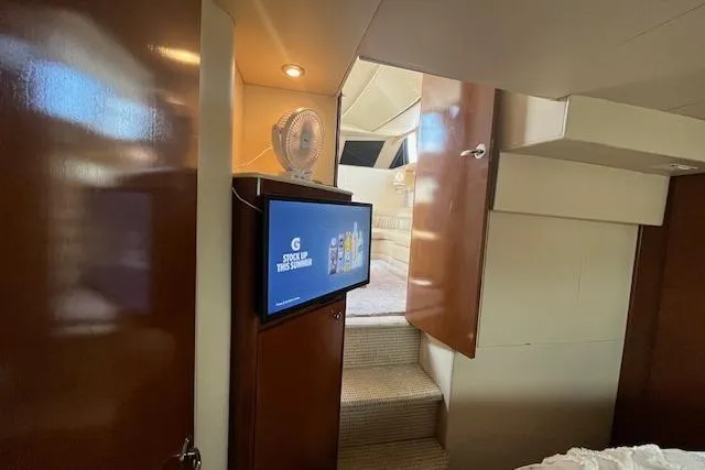 The Wanderer Yacht Photos Pics Interior of 2005 Meridian 368 Motoryacht with TV and wooden cabinetry.