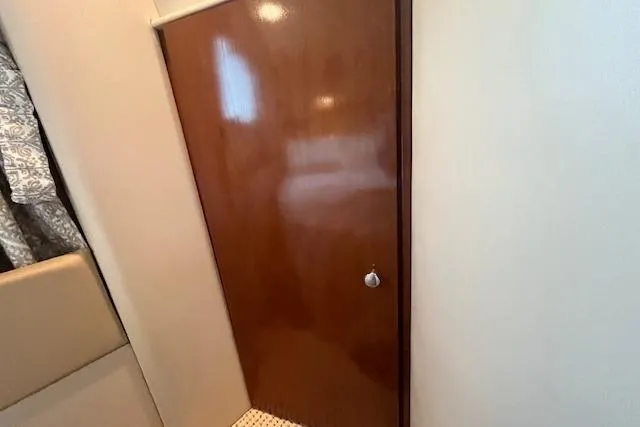 The Wanderer Yacht Photos Pics Interior of 2005 Meridian 368 Motoryacht with wooden door and patterned flooring.