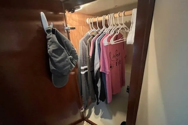 The Wanderer Yacht Photos Pics Closet in 2005 Meridian 368 Motoryacht with hanging clothes and hats.