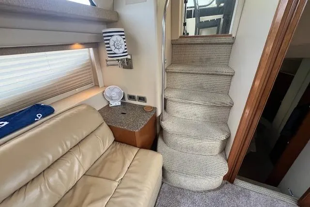 The Wanderer Yacht Photos Pics Interior of 2005 Meridian 368 Motoryacht with beige seating and carpeted stairs.
