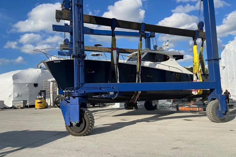  Yacht Photos Pics Custom NNS Sea Scout 41 yacht, 2007, lifted by a blue crane under a clear sky.