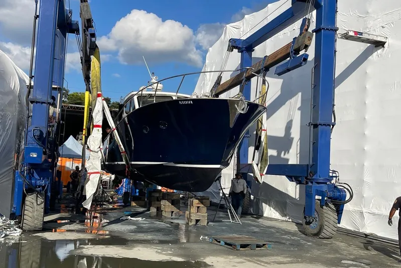  Yacht Photos Pics Custom NNS Sea Scout 41 boat from 2007 being lifted by a blue crane.