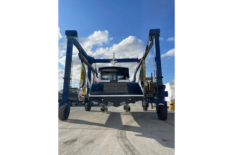  Yacht Photos Pics Custom NNS Sea Scout 41 boat, 2007 model, on a lift under a clear blue sky.
