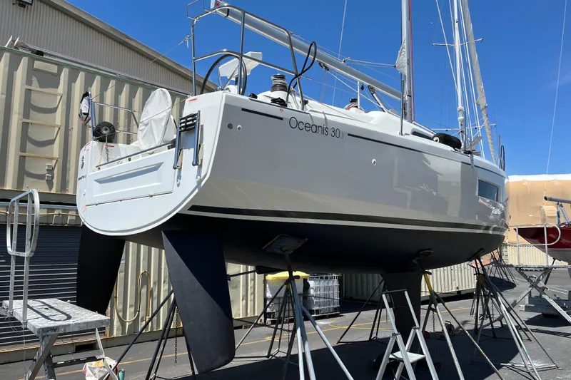 Polaris Yacht Photos Pics 2021 Beneteau Oceanis 30.1 sailboat on stands, in a shipyard setting.
