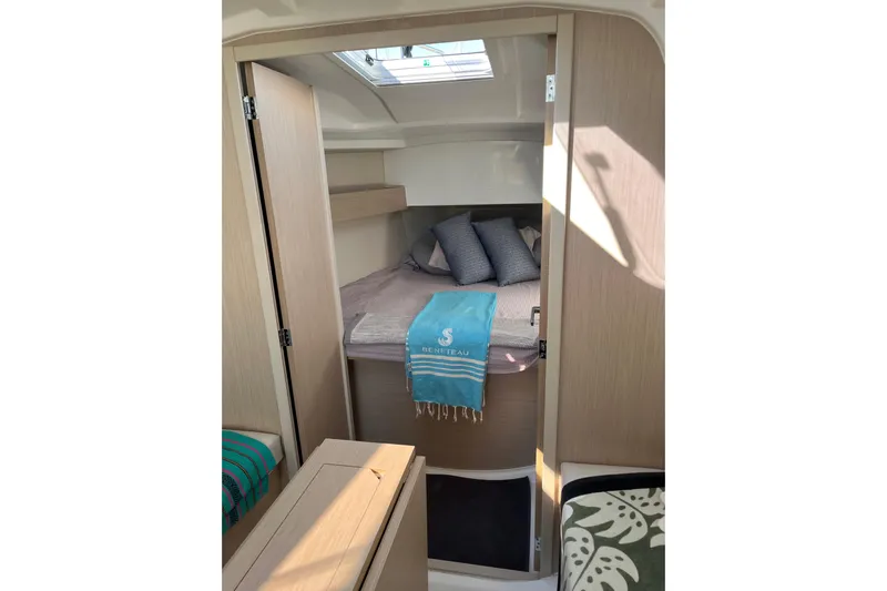 Polaris Yacht Photos Pics Cozy cabin interior of 2021 Beneteau Oceanis 30.1 sailboat with bed and skylight.