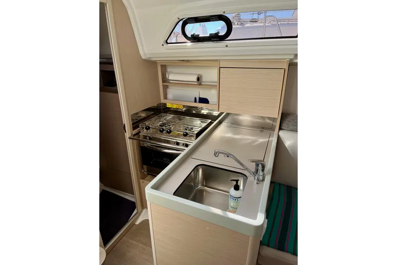 Polaris Yacht Photos Pics Compact kitchen area in 2021 Beneteau Oceanis 30.1 yacht with stove and sink.