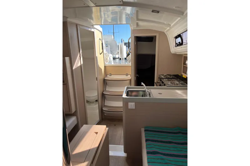 Polaris Yacht Photos Pics Interior of 2021 Beneteau Oceanis 30.1 yacht, featuring kitchen and seating area.