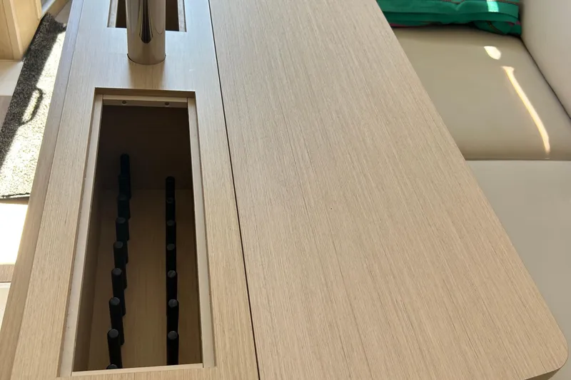 Polaris Yacht Photos Pics Interior view of 2021 Beneteau Oceanis 30.1 yacht with wooden table and seating.