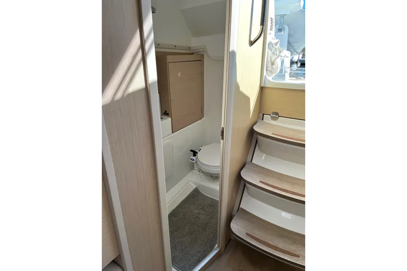 Polaris Yacht Photos Pics Interior of 2021 Beneteau Oceanis 30.1 yacht, featuring compact bathroom and wooden steps.