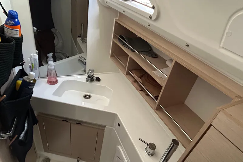 Polaris Yacht Photos Pics Interior of 2021 Beneteau Oceanis 30.1 yacht bathroom with sink and storage shelves.